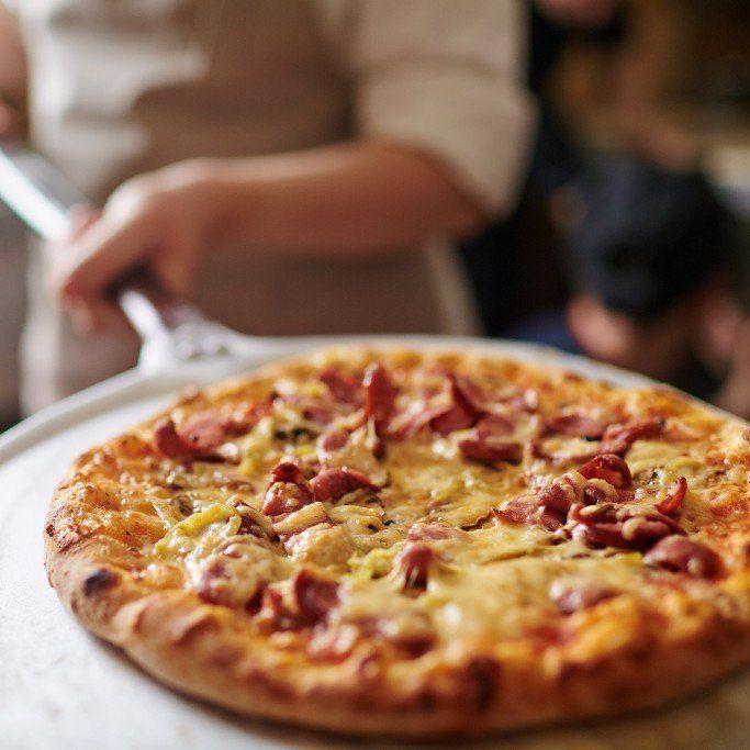 A pizza with a lot of cheese and meat on it