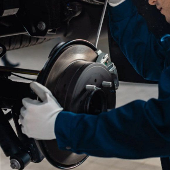 Mechanic Checking Brakes — Automotive Repair in Townsville