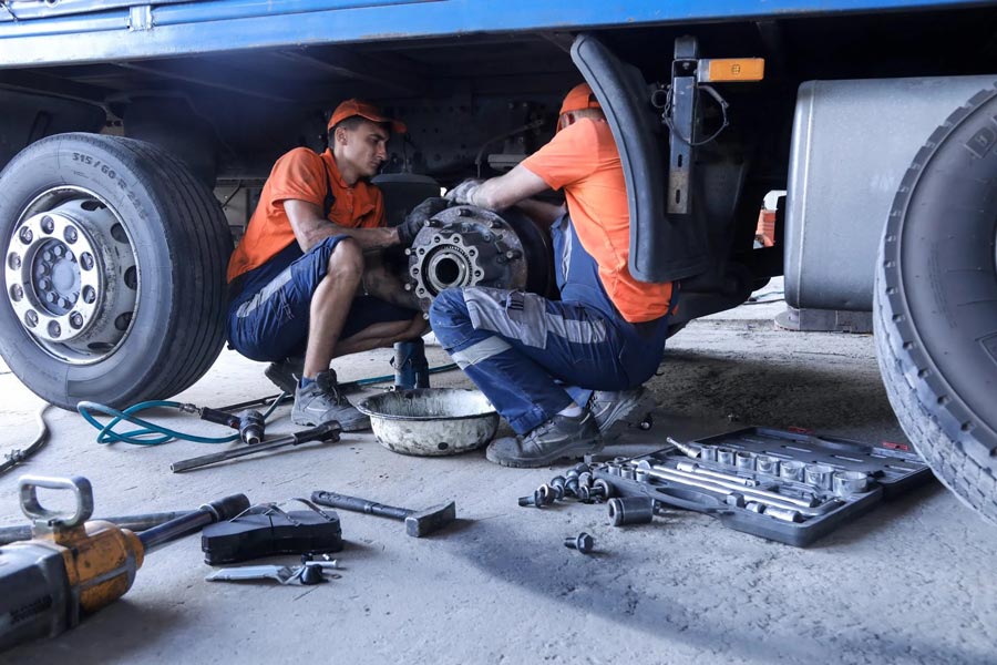 Two Mechanic Repairing Truck Brakes — Automotive Repair in Townsville
