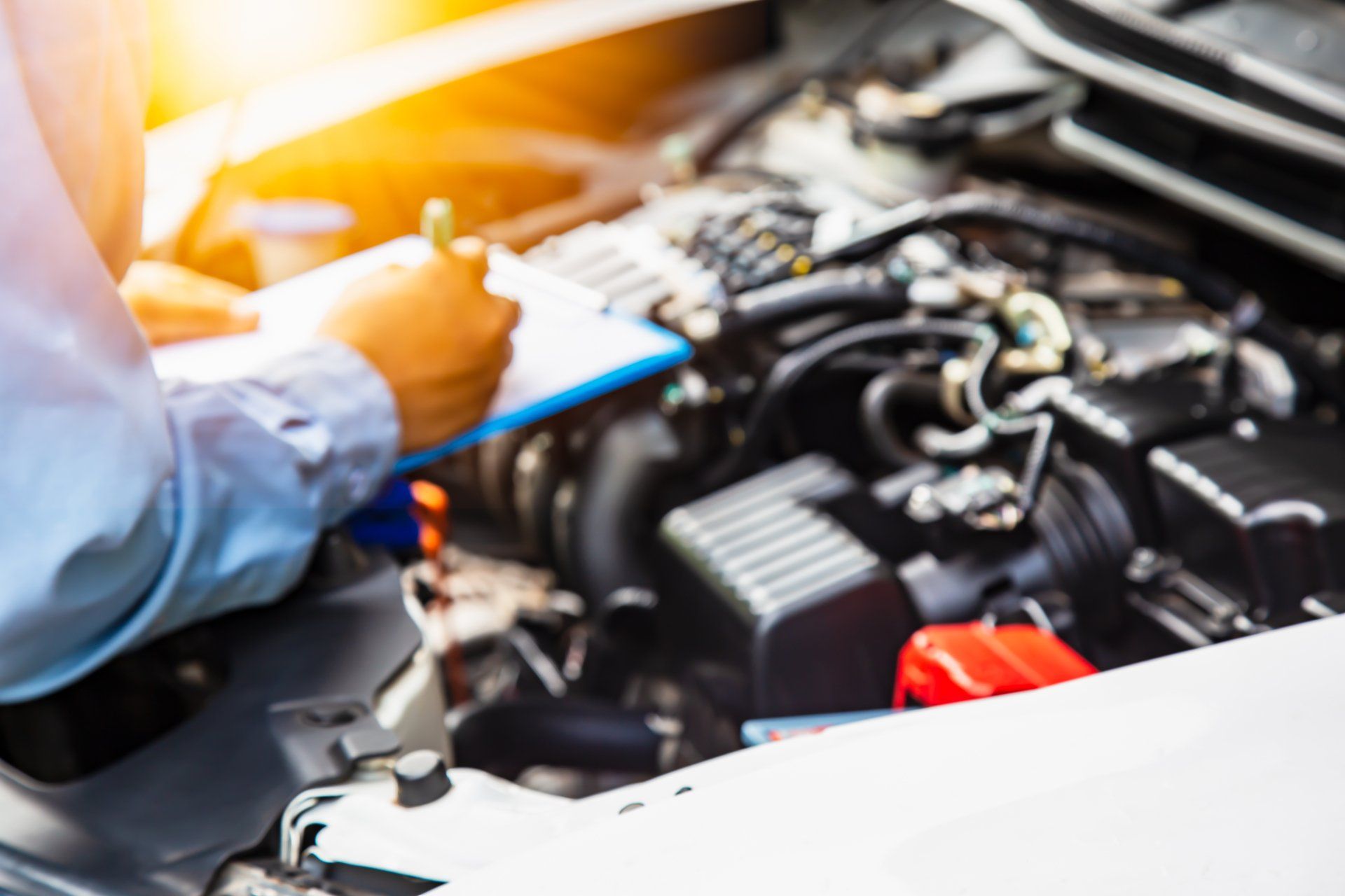 Mechanic Checking Engine With Card Board — Automotive Repair in Townsville