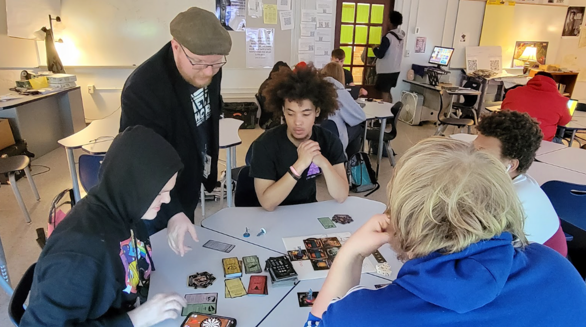 A group of people are sitting around a table playing a game.