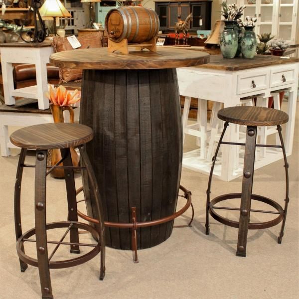Rustic barrel-style table with two wooden stools in a shop display.