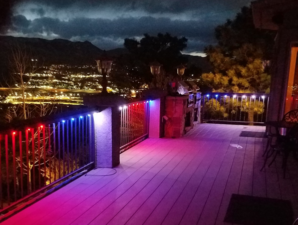 A deck with a view of a city at night