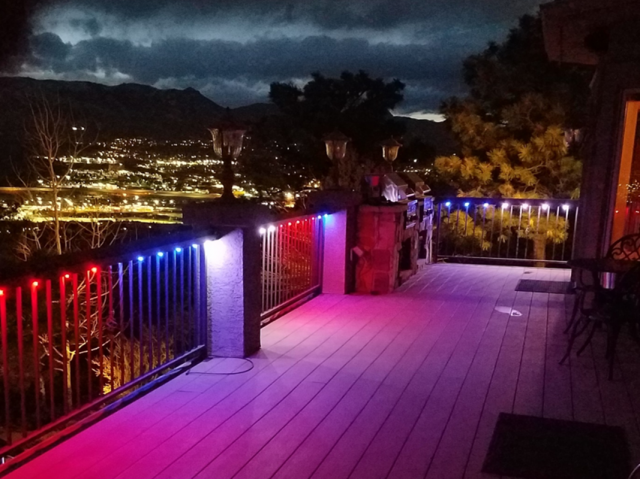 A deck with red , blue and purple permanent lights on it