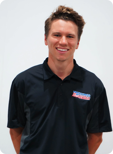 A man wearing a black polo shirt with a logo on it