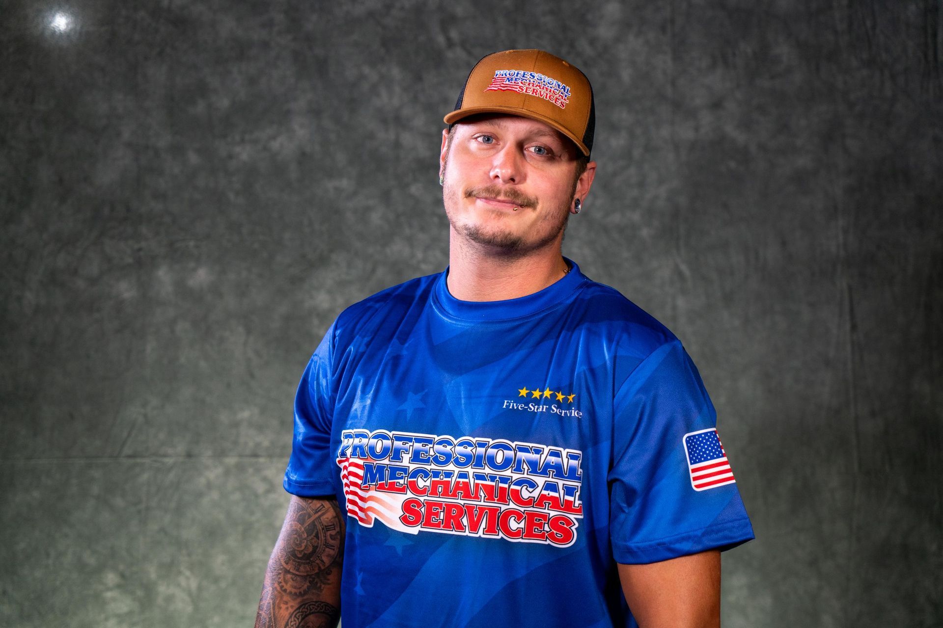 A man wearing a hat and a black shirt with the word smith on it