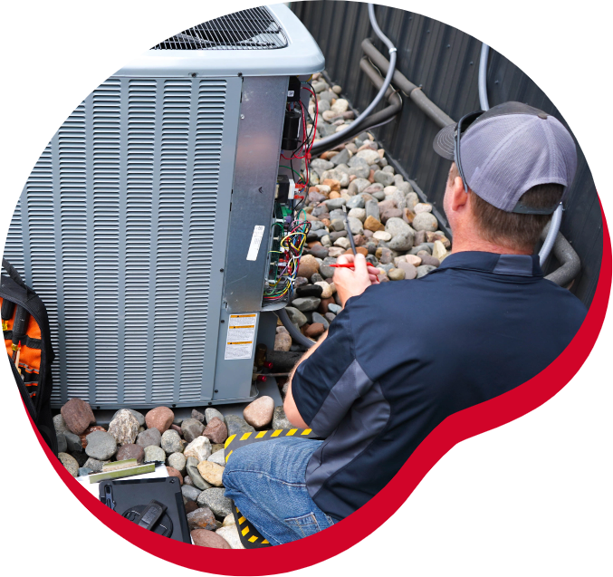 A man is working on an air conditioner with a screwdriver