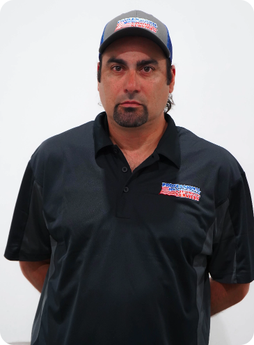 A man with a beard wearing a hat and a shirt that says all american masters