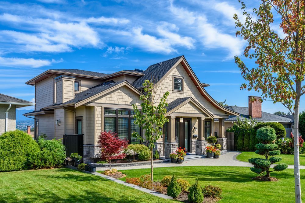A large house with a lush green lawn in front of it.
