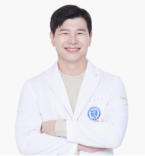 A smiling Asian man in a white lab coat stands against a white background. He's wearing a black shirt and has short, dark hair.