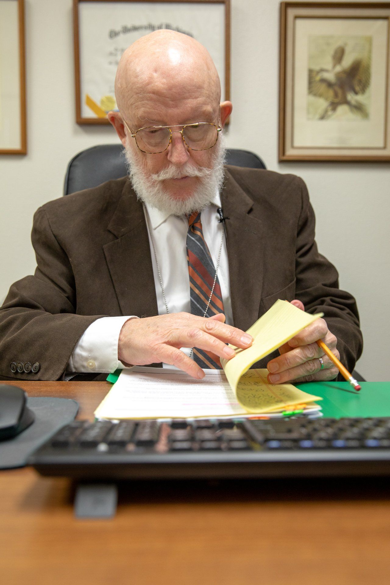 man looking at legal papers at desk