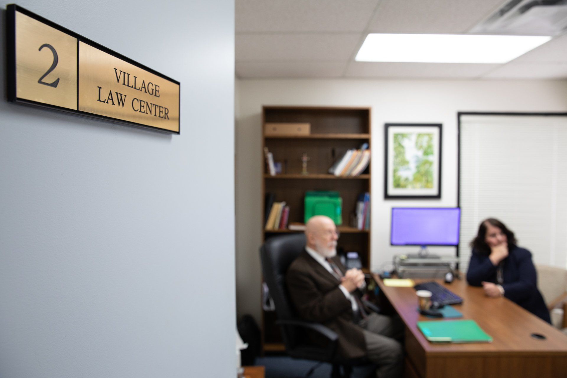 man and woman sitting in law center office