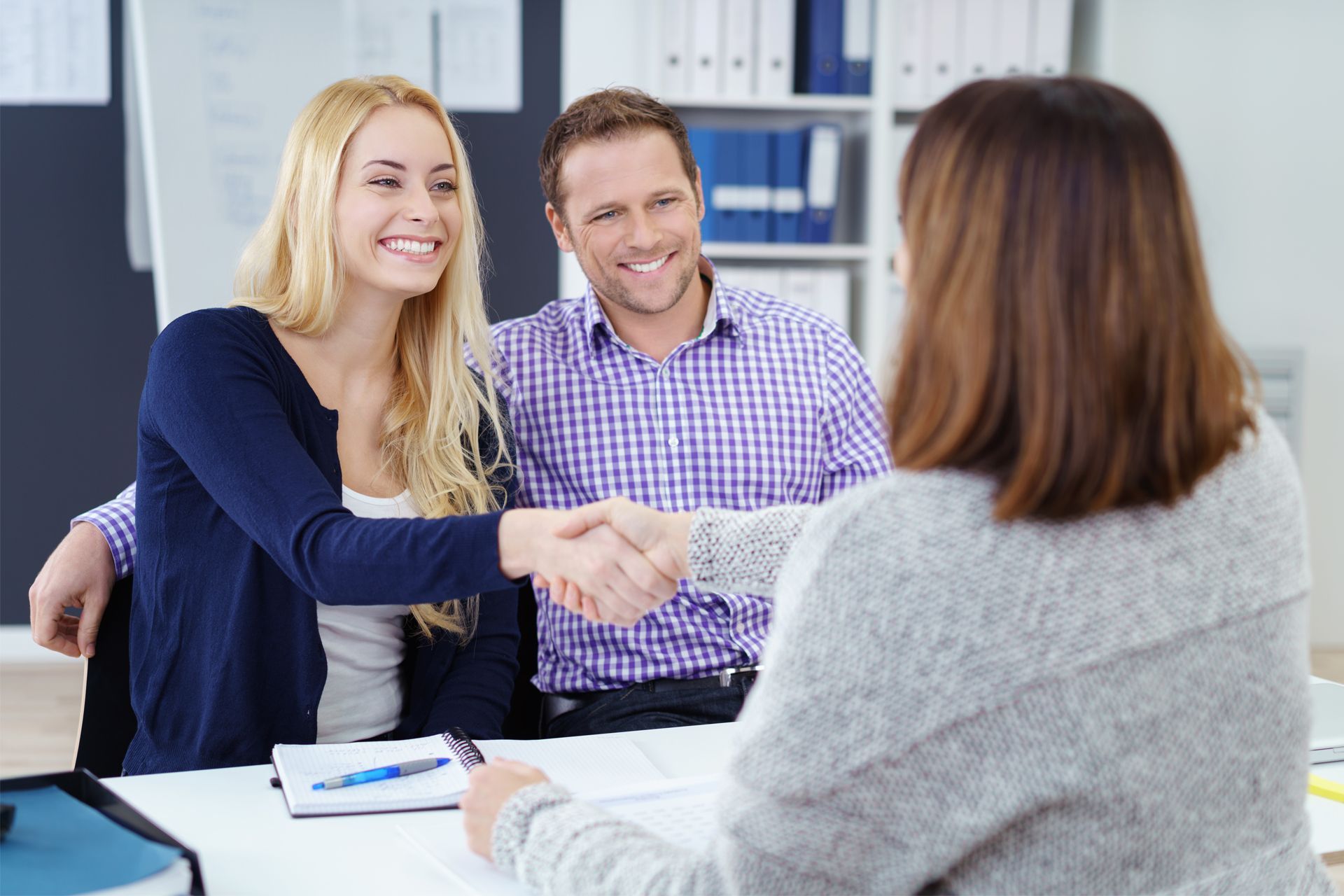 Happy Couple Shaking Hand With Their Financial Advisor