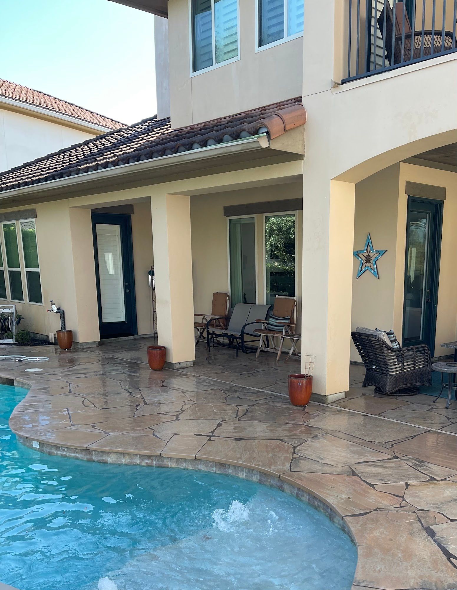 A large house with a swimming pool in front of it