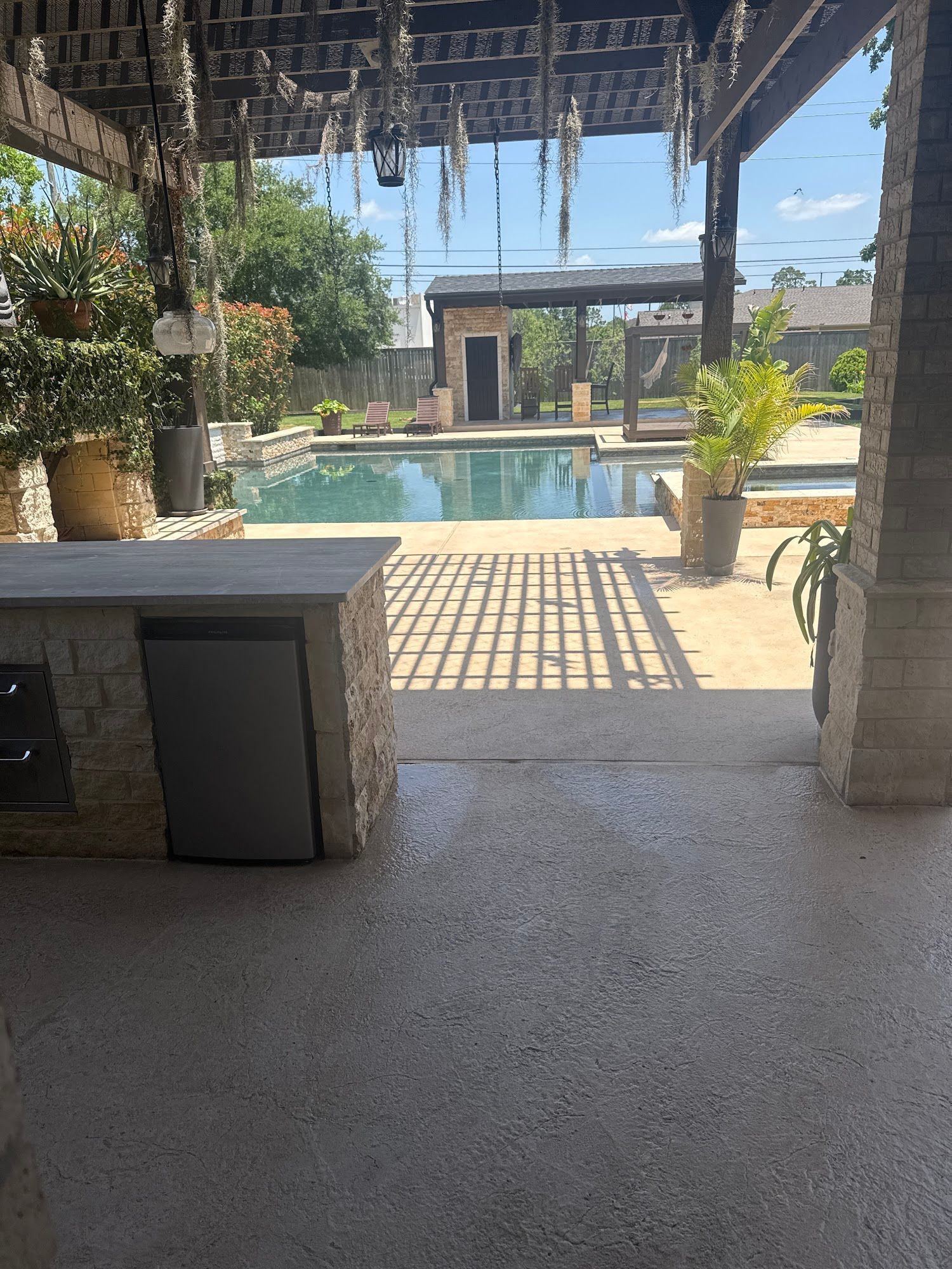 A view of a swimming pool from a patio area.