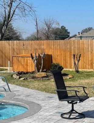 A chair is sitting on a patio next to a pool.