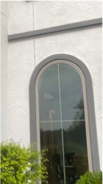 A white building with a large arched window