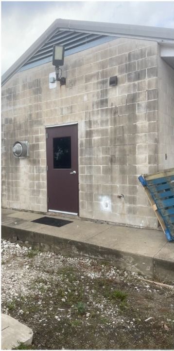 A brick building with a brown door and a window