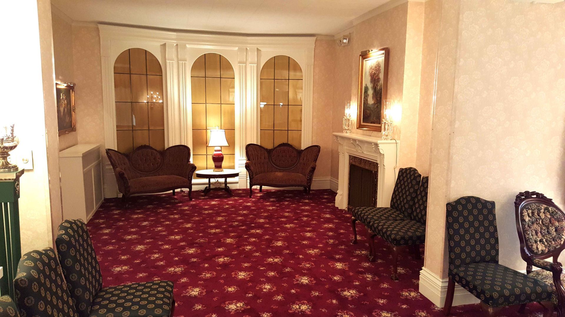 A living room with a fireplace and a couch and chairs