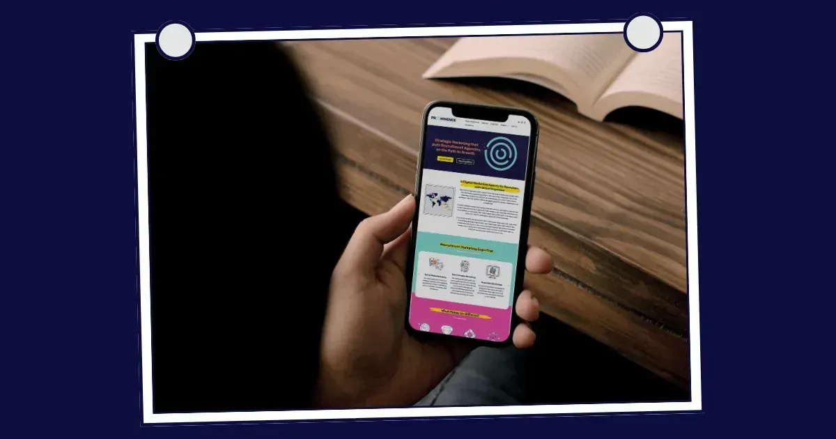 Person holding phone with app open, showing website info. Book on wooden table in background.