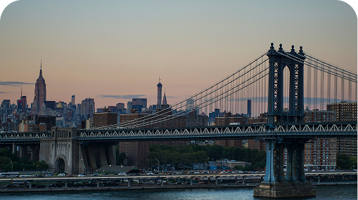 Manhattan Bridge and skyline at dusk.