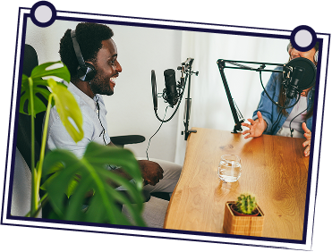 A group of people having a meeting at a table, discussing documents.