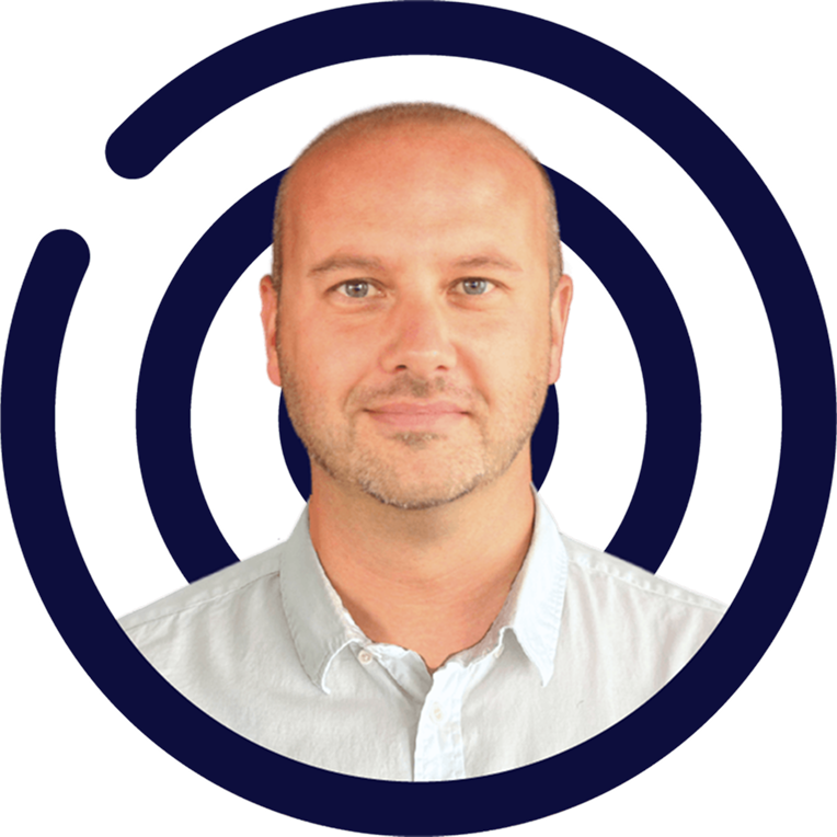 Man with a shaved head in a light blue shirt, set against a dark blue concentric circle design.