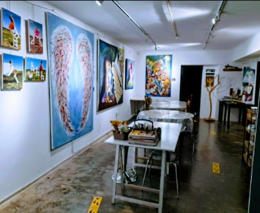 collection of paintings and murals decorating a cave studio