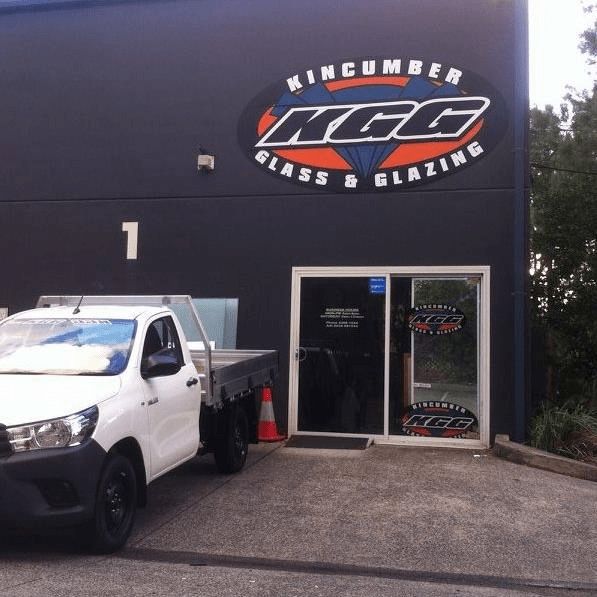 A White Truck is Parked in Front of a Building That Says Kcg Glass and Glazing — Kincumber Glass & Glazing in Kincumber, NSW
