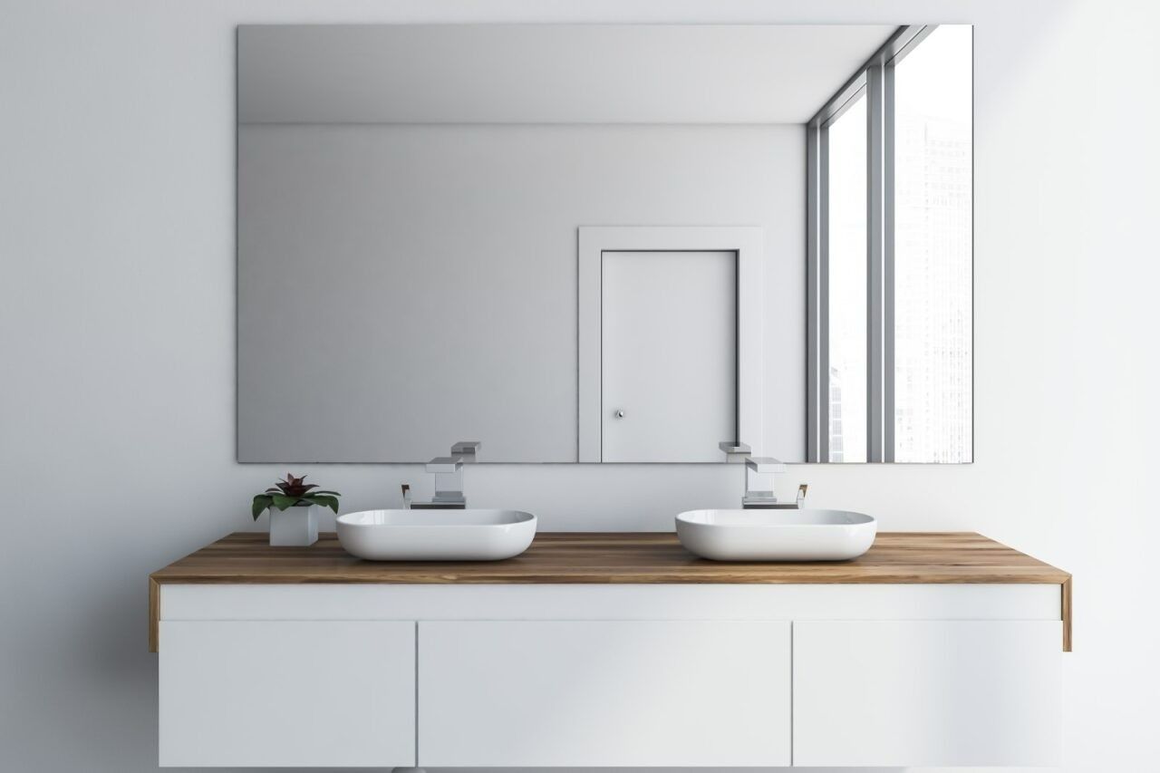 A Bathroom With Two Sinks and a Large Mirror — Kincumber Glass & Glazing in Kincumber, NSW