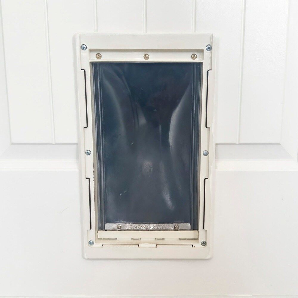 A Close Up of a Dog Door on a White Door — Kincumber Glass & Glazing in Kincumber, NSW