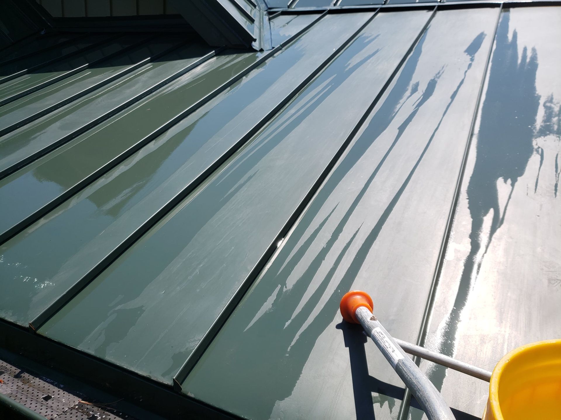 A green roof with a yellow bucket next to it