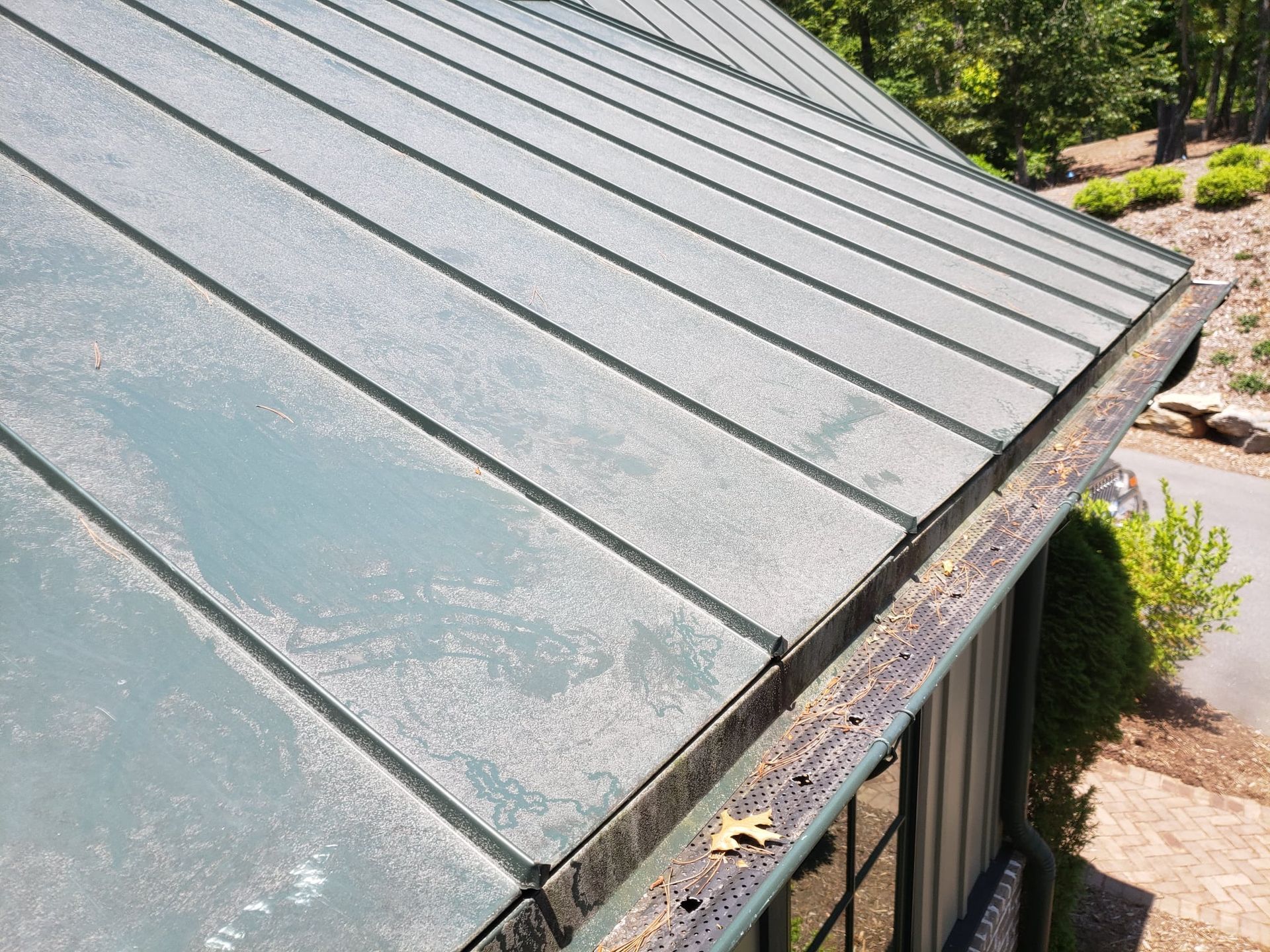 A close up of a roof with a gutter on it.