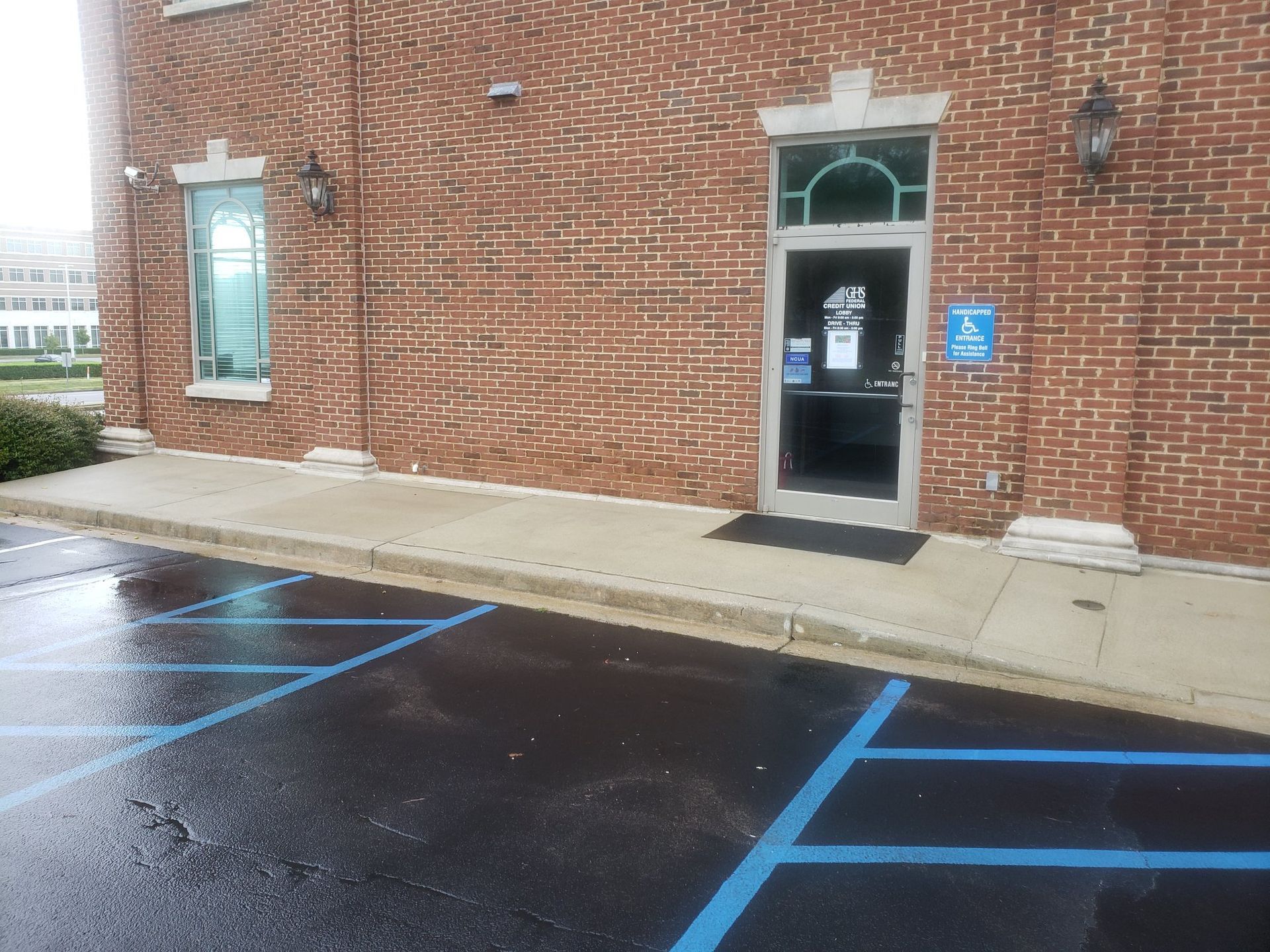 A brick building with a parking lot in front of it