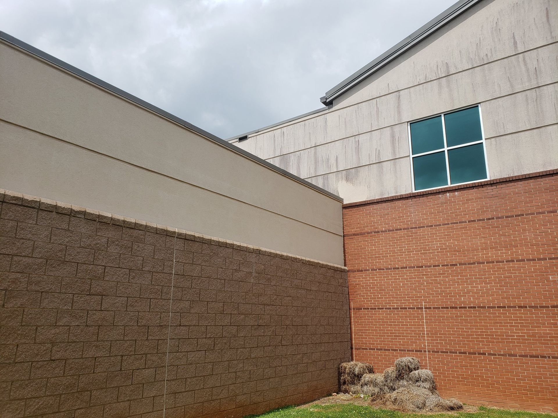 A building with a brick wall and a window