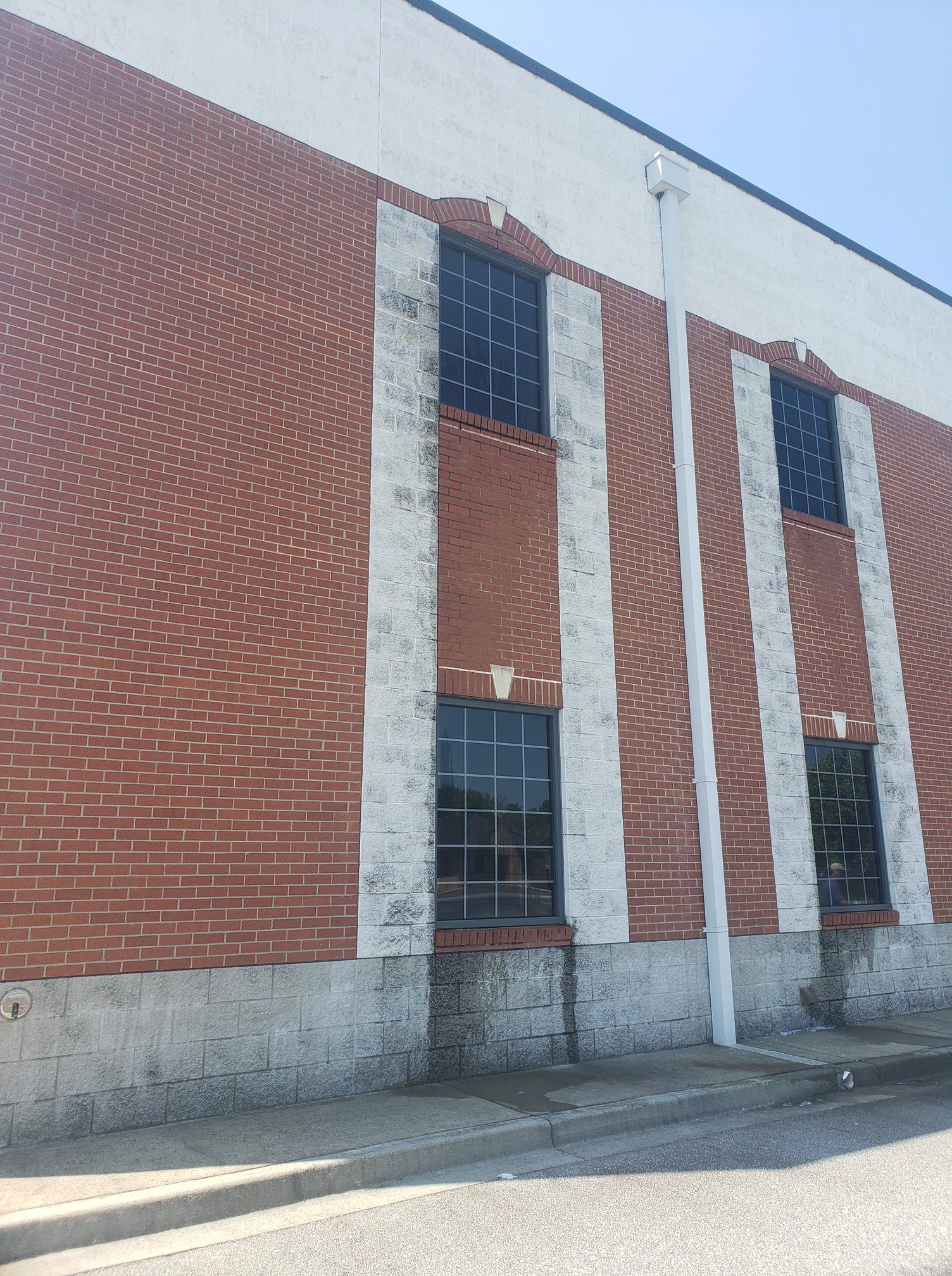 A red brick building with white trim and black windows