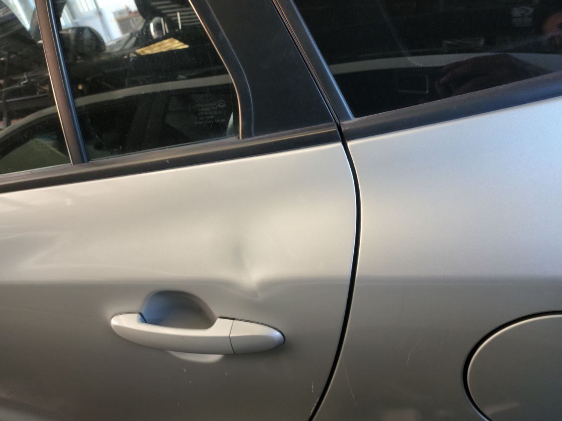 White Car Door With A Dent — Dent Repair Specialist in Kunda Park, QLD