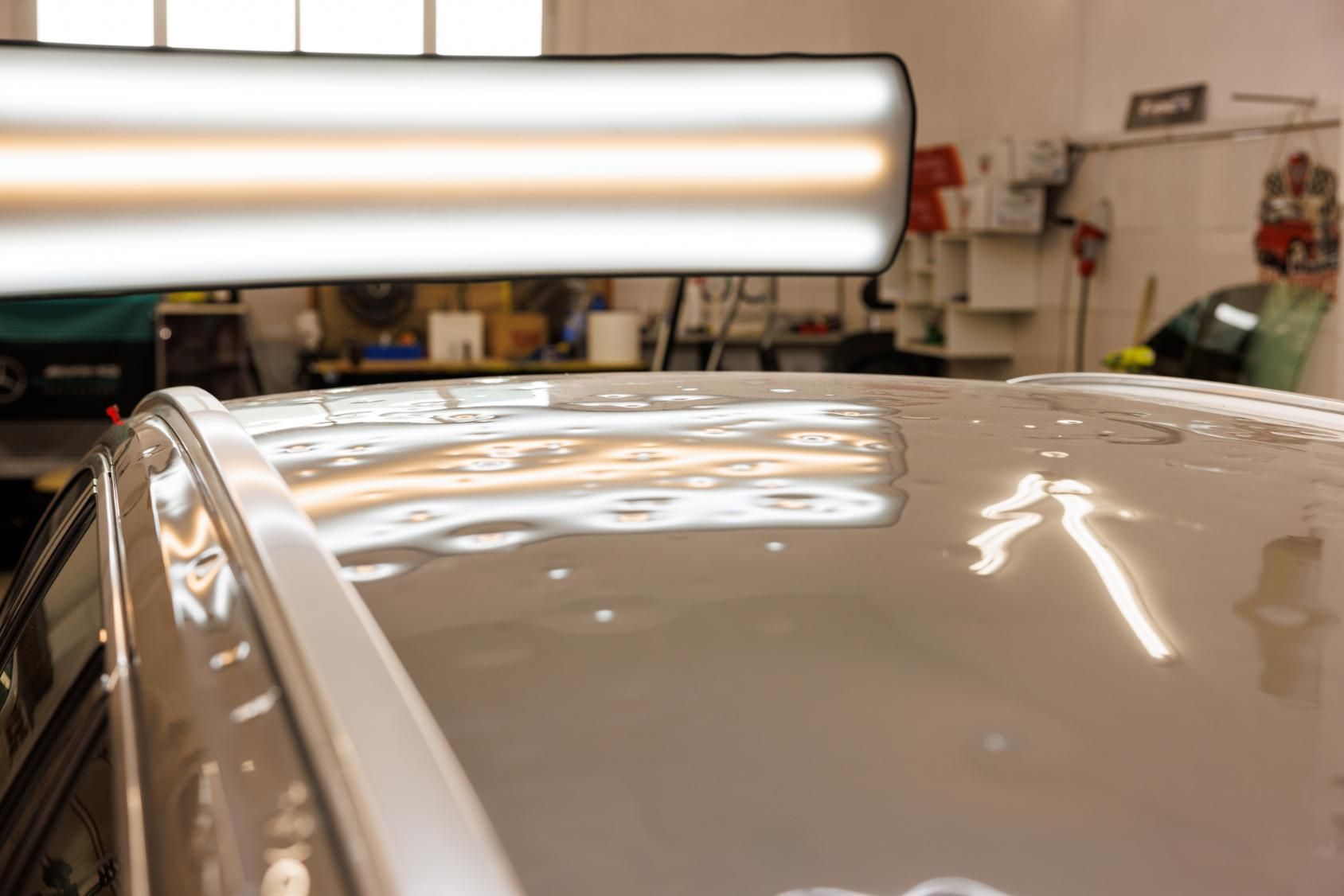 The Roof of A Car Is Being Repaired in A Garage — Dent Repair Specialist in Maroochydore, QLD