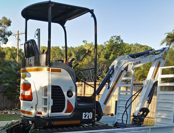 A small excavator with the number e20 on it