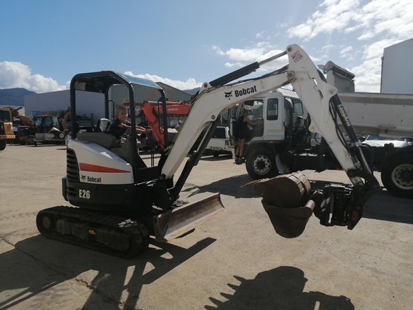 A bobcat excavator is parked in a parking lot