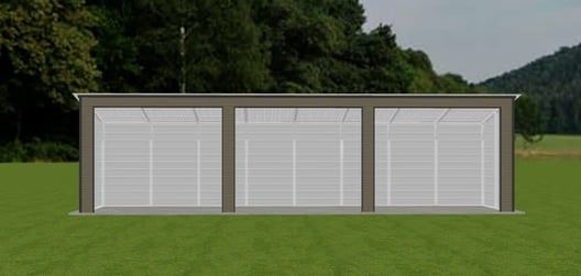 A three-bay garage with white doors, surrounded by green grass and trees.