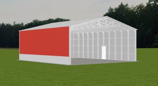 Red-walled and white metal structure on green grass, with open entrance and a forest in background.