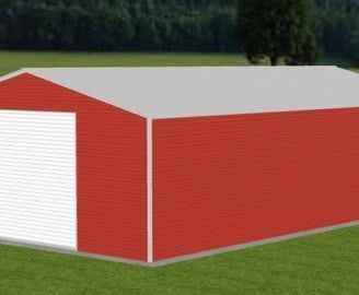 Red metal building with a white garage door, set in a grassy area with a tree line background.