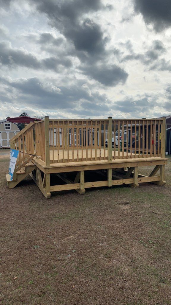 Gray shed with black doors and white-framed windows, against a gray sky.