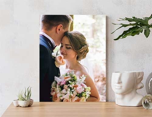 Groom and Bride in metal print leaning against the wall