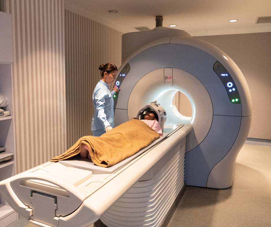 A patient standing in front of an X Ray machine