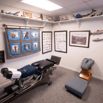 A picture of a chiropractic office with a seat
