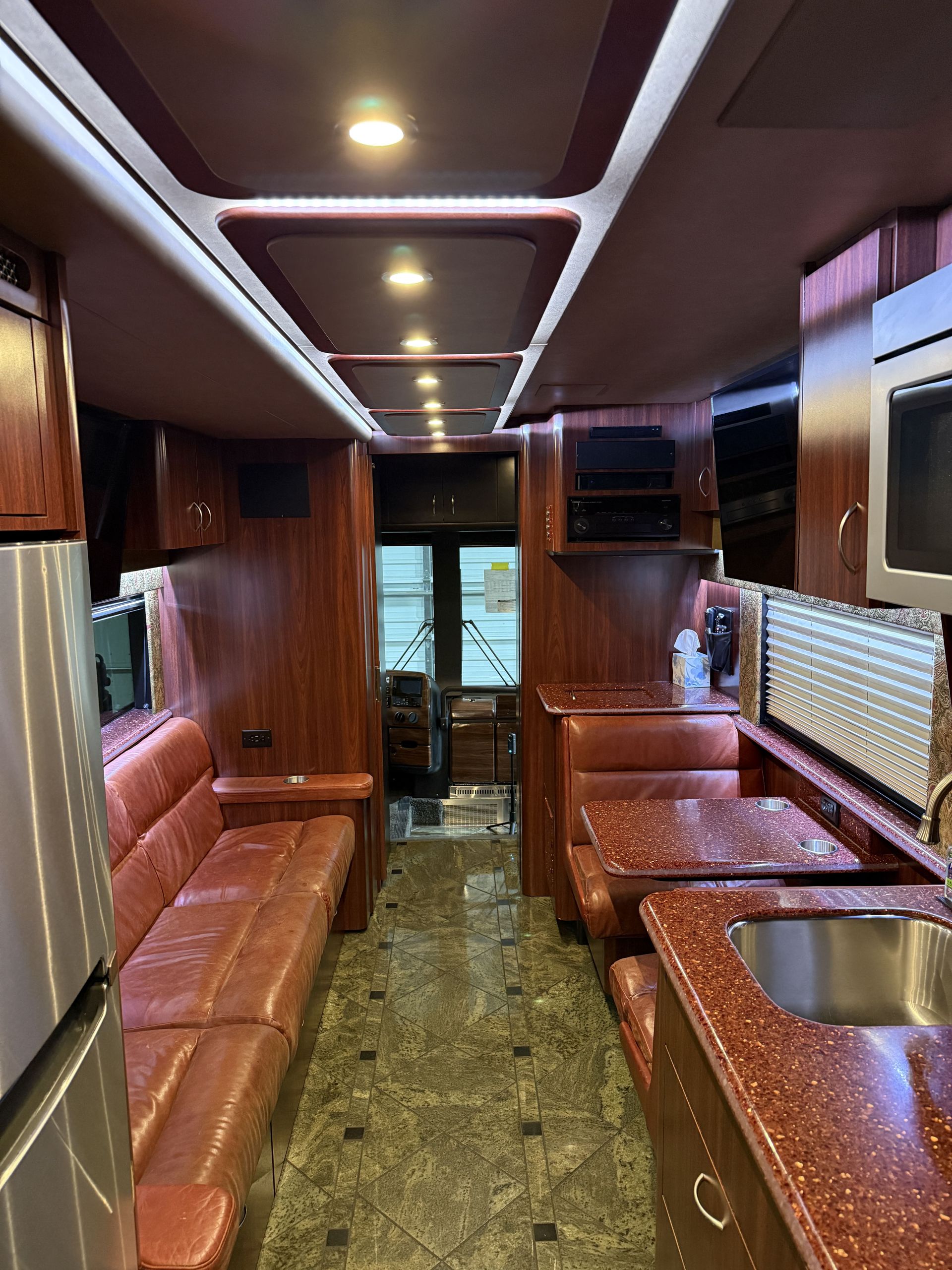 Kitchen area with microwave, refrigerator, and coffee maker inside Coach 14