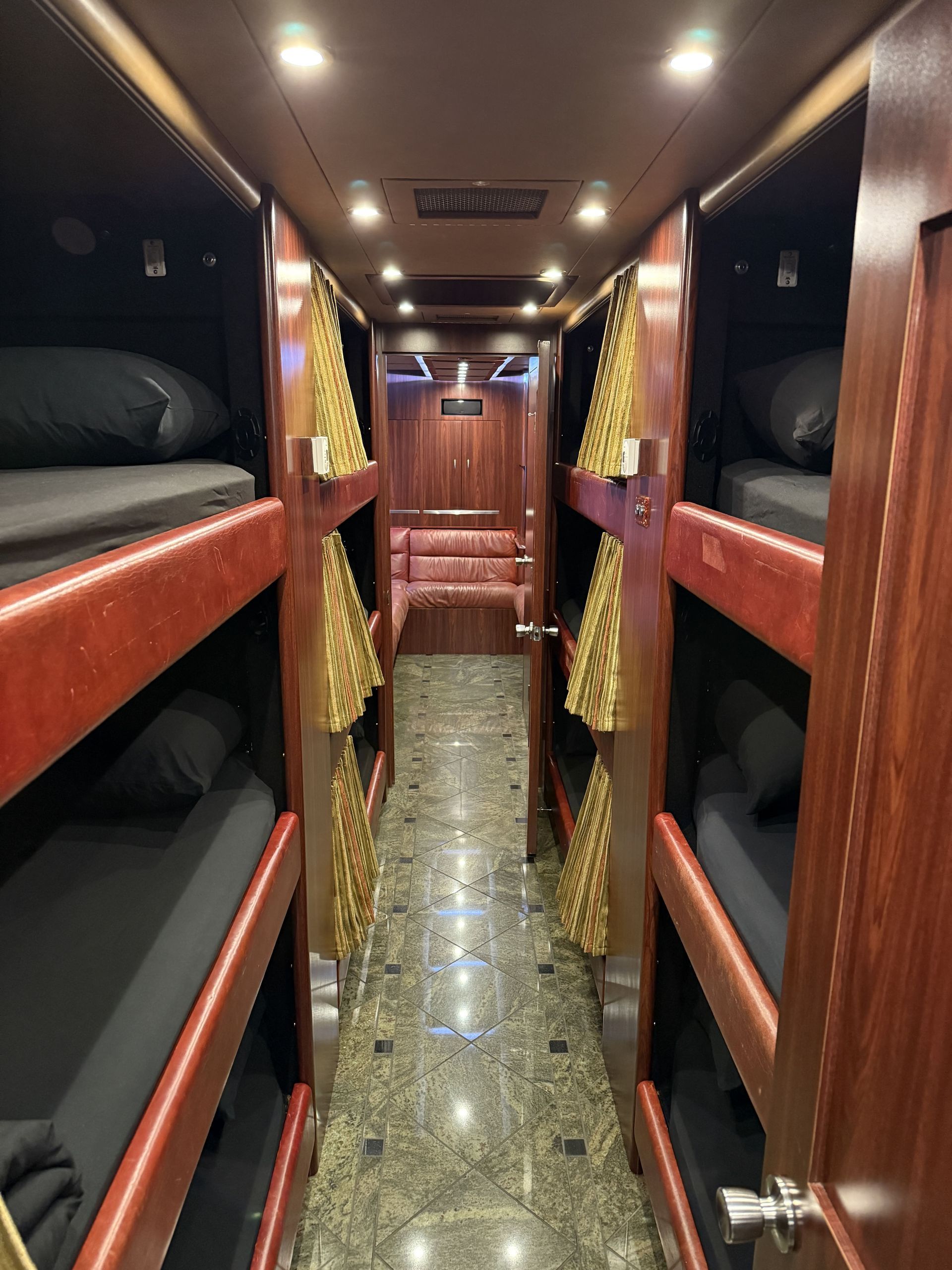 interior lounge of Coach 14 with plush seating, ambient lighting, and entertainment system