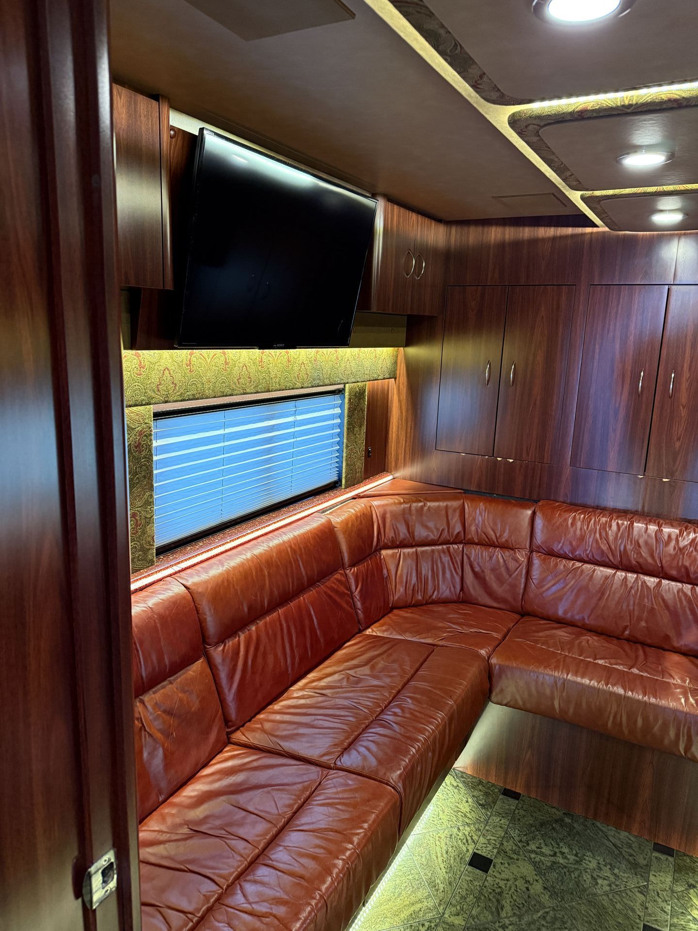 Coach 15 front slide-out expanded to reveal luxurious open living area